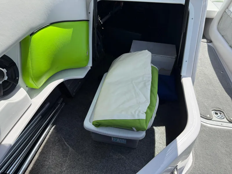 Slide: The Image of Interior of 2007 Nautique Air SV-211 boat with storage compartment and green cushion. - 26