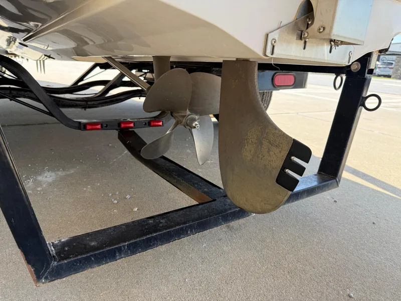 Slide: The Image of 2007 Nautique Air SV-211 boat propeller and rudder on trailer. - 28