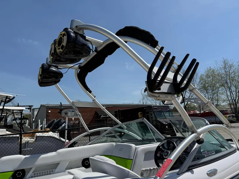 Slide: The Image of 2007 Nautique Air SV-211 boat with wakeboard tower and speakers, parked outdoors. - 30