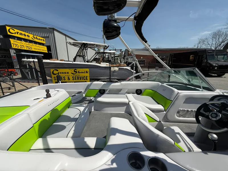 Slide: The Image of 2007 Nautique Air SV-211 boat interior with green accents at Cross Shack Sales & Service. - 31