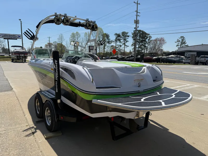 Slide: The Image of 2007 Nautique Air SV-211 boat on trailer, parked roadside, featuring sleek design and vibrant accents. - 4
