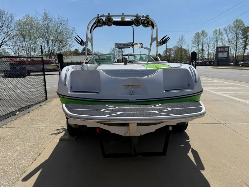 Slide: The Image of 2007 Nautique Air SV-211 boat with wakeboard tower, parked on pavement. - 5