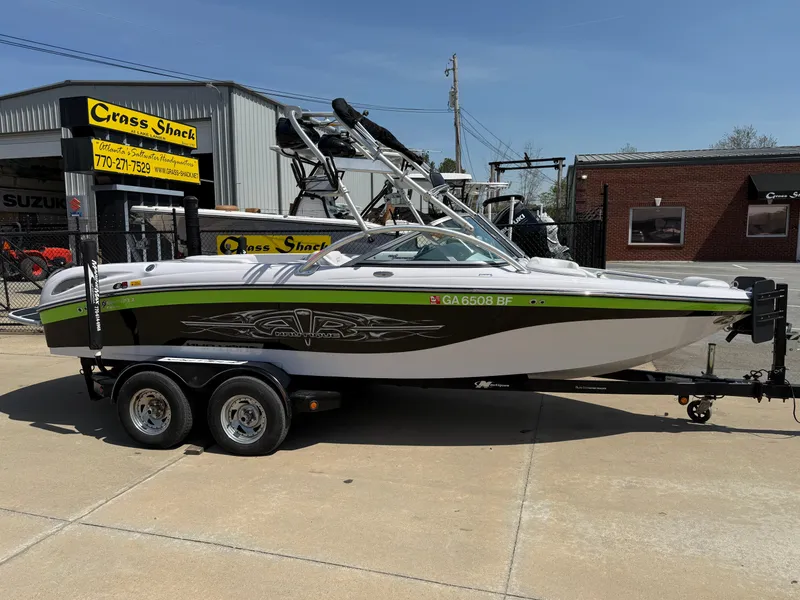 Slide: The Image of 2007 Nautique Air SV-211 boat on trailer, parked outside dealership. - 7