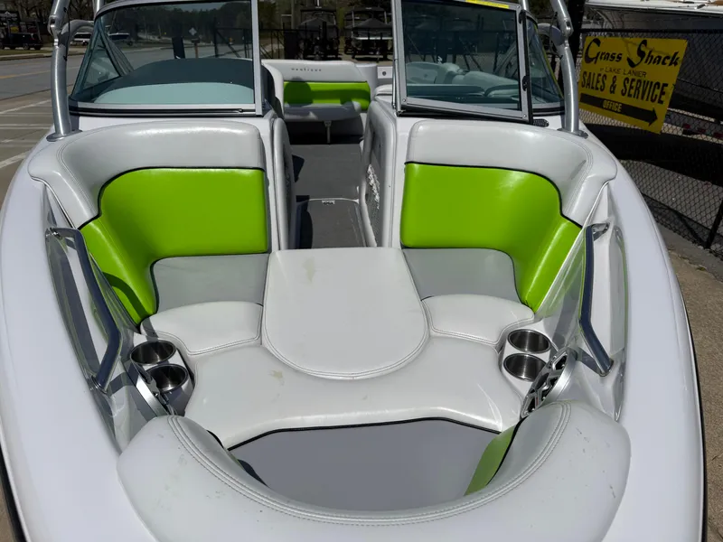 Slide: The Image of 2007 Nautique Air SV-211 boat interior with green and white seating. - 8