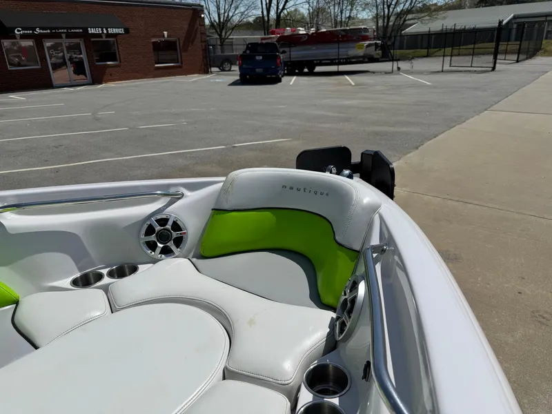 Slide: The Image of 2007 Nautique Air SV-211 boat interior with green and white seating in a parking lot. - 9