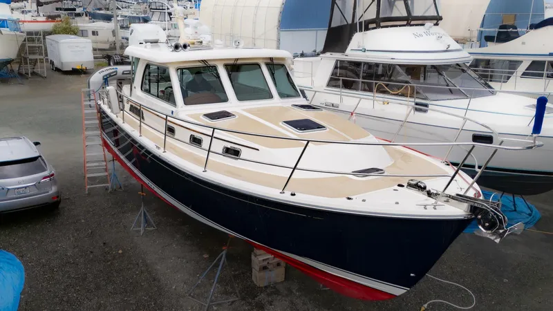 The Image of 2014 Sabre 38 Salon Express yacht in a marina, elevated on stands. - 0