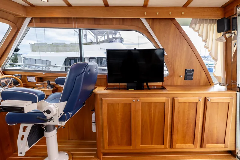 Slide: The Image of Interior of 2014 Sabre 38 Salon Express with wooden cabinetry and blue captain's chair. - 11