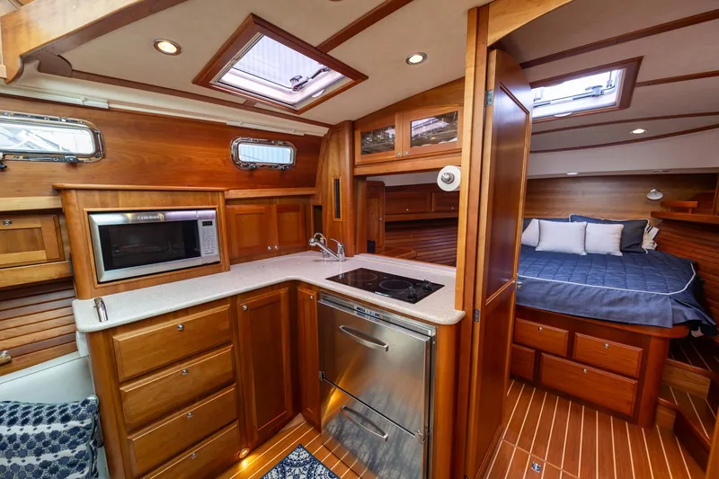 Slide: The Image of 2014 Sabre 38 Salon Express interior with wood cabinetry, kitchen, and cozy sleeping area. - 17