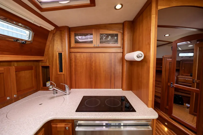Slide: The Image of 2014 Sabre 38 Salon Express kitchen with wood cabinetry and modern appliances. - 18