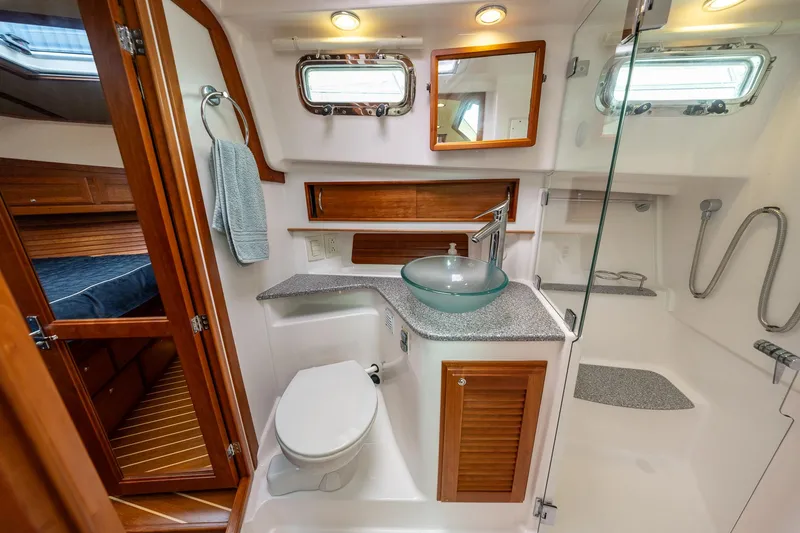 Slide: The Image of Luxurious bathroom in 2014 Sabre 38 Salon Express yacht with modern fixtures and wood accents. - 24
