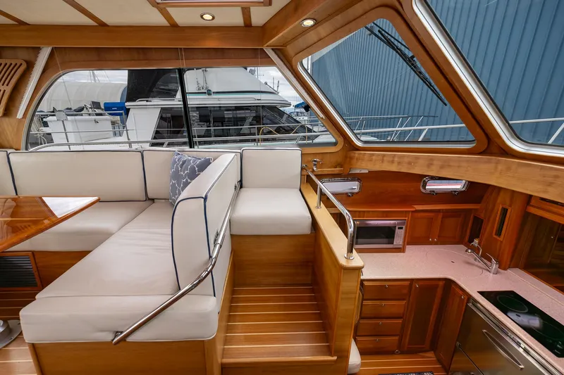 Slide: The Image of Interior of 2014 Sabre 38 Salon Express yacht with wood finish and seating area. - 7