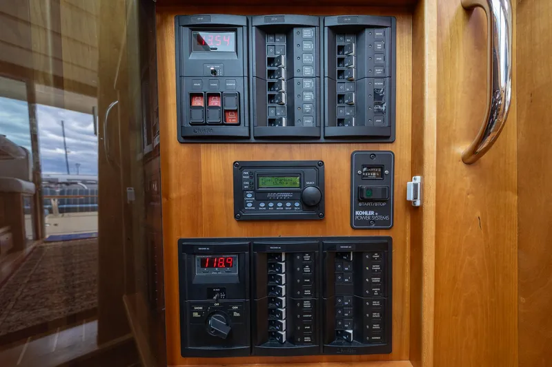 Slide: The Image of Electrical control panel on 2014 Sabre 38 Salon Express yacht, featuring switches and displays. - 9