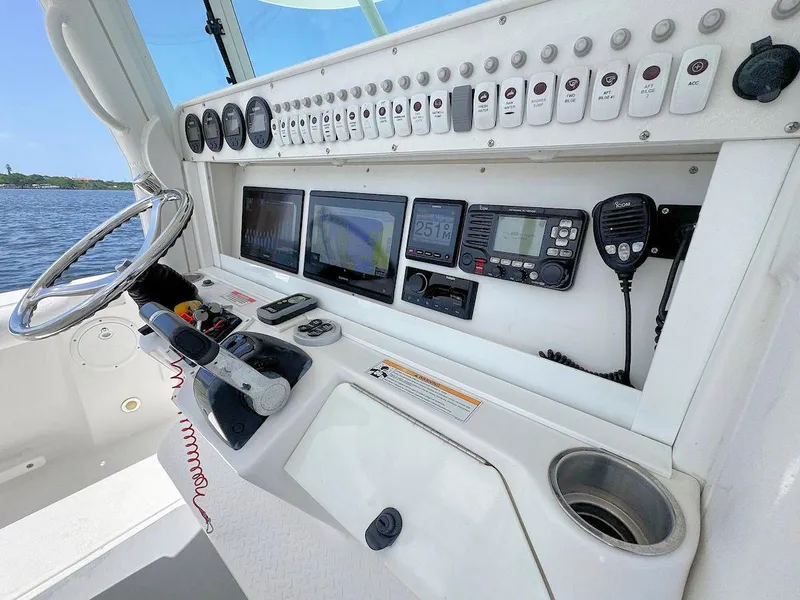 Slide: The Image of Control panel of a 2010 Everglades 350 CC boat with navigation and communication equipment. - 12