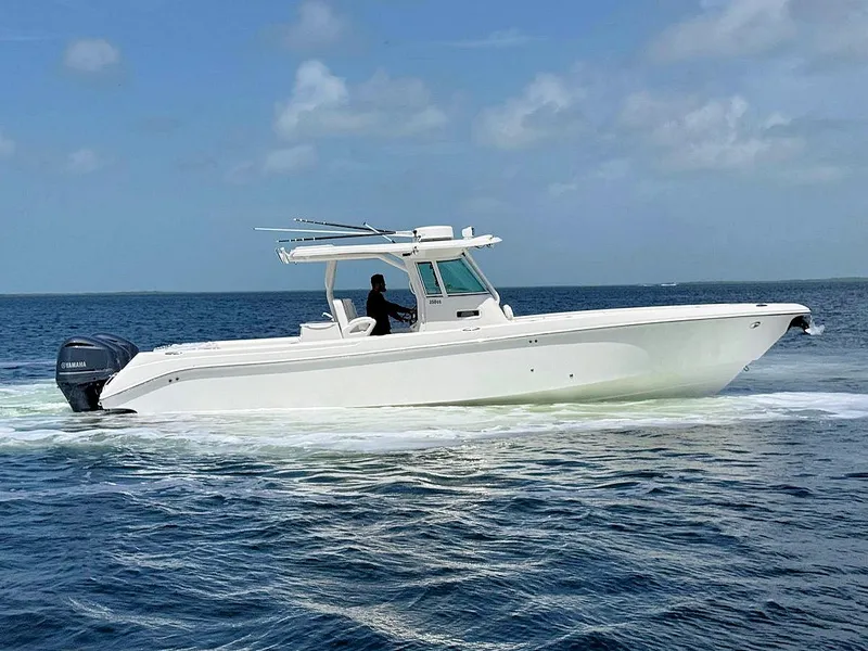 Slide: The Image of 2010 Everglades 350 CC boat cruising on open water under a clear sky. - 3