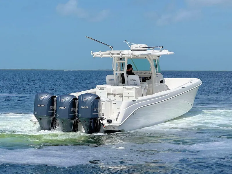 Slide: The Image of 2010 Everglades 350 CC boat with triple Yamaha engines cruising on open water. - 4