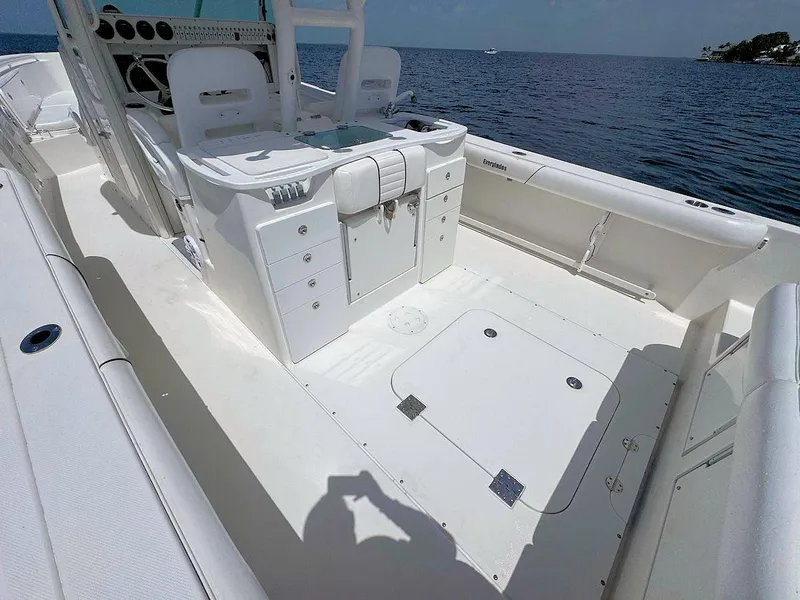 Slide: The Image of 2010 Everglades 350 CC boat interior with storage compartments, on a calm sea. - 9