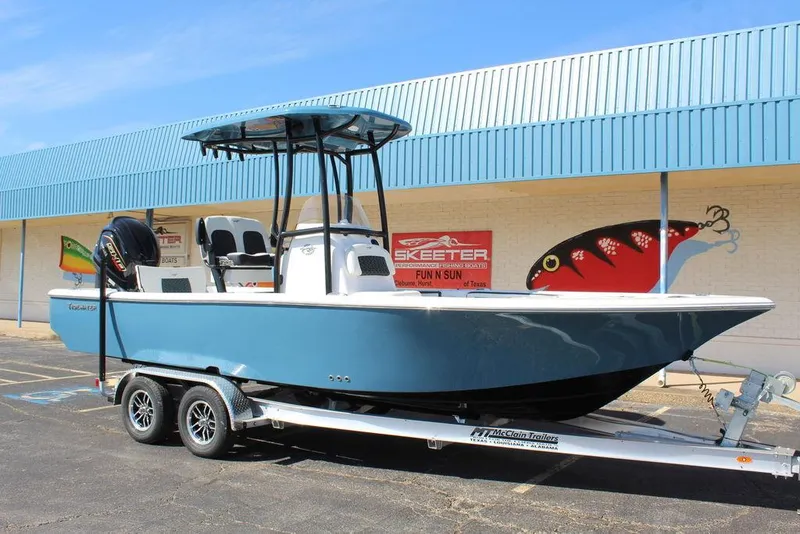 The Image of Tidewater 2300 CB 2025 boat on trailer, parked outside a building. - 1