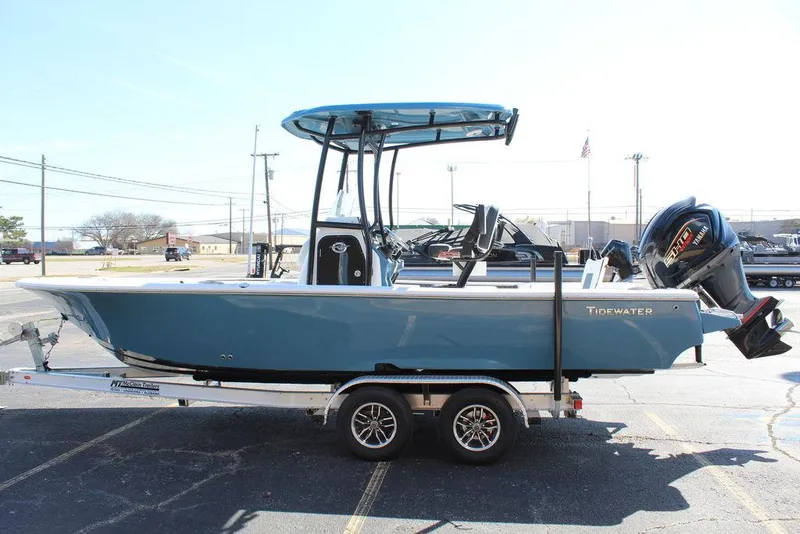 Slide: The Image of 2025 Tidewater 2300 CB boat on trailer, blue hull, center console, outboard motor. - 11