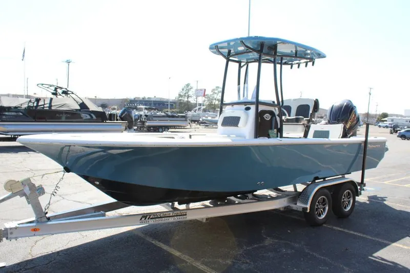 Slide: The Image of 2025 Tidewater 2300 CB boat on trailer, blue hull, parked outdoors. - 12