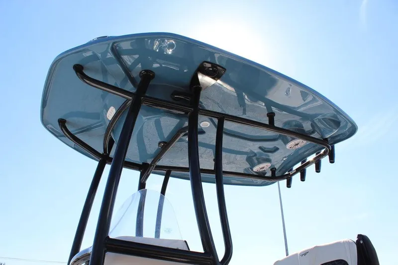 Slide: The Image of Tidewater 2300 CB 2025 boat with sleek blue T-top against clear sky. - 14