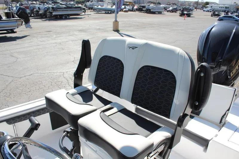 Slide: The Image of 2025 Tidewater 2300 CB boat seats with modern design in a marina setting. - 15