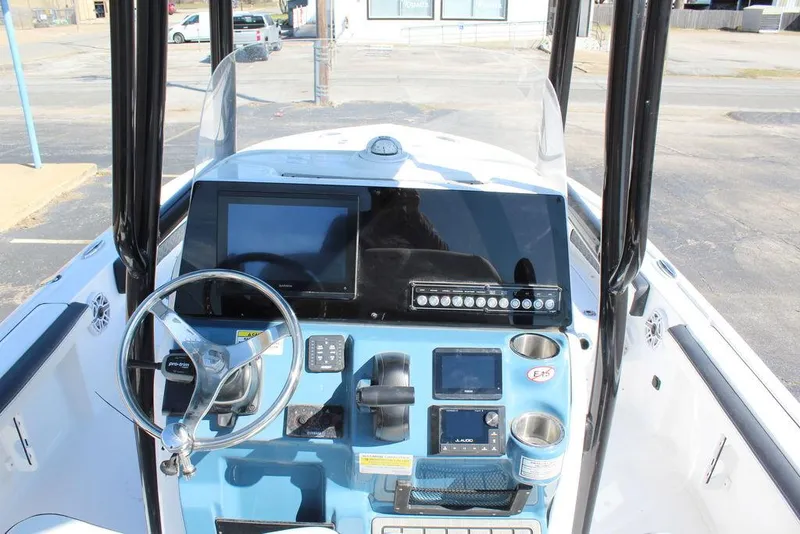 Slide: The Image of 2025 Tidewater 2300 CB boat dashboard with modern controls and navigation screens. - 17