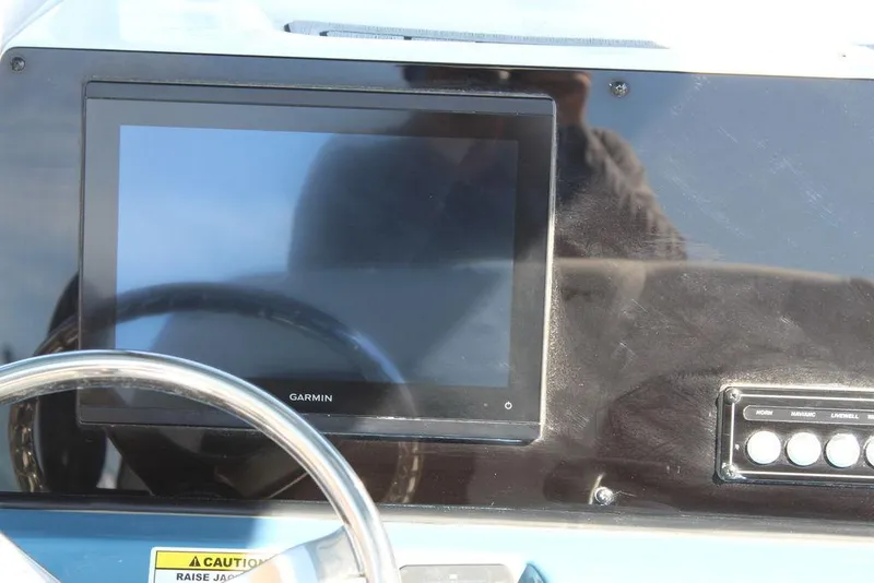 Slide: The Image of Dashboard of 2025 Tidewater 2300 CB boat with Garmin display and controls. - 18