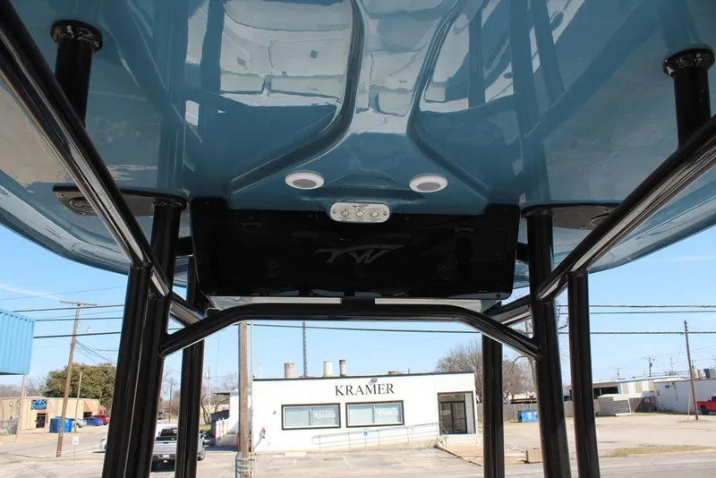 Slide: The Image of 2025 Tidewater 2300 CB boat underside view with blue hull and sturdy black supports. - 19