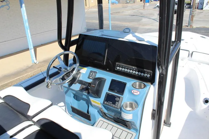 Slide: The Image of 2025 Tidewater 2300 CB boat console with steering wheel and modern controls. - 20