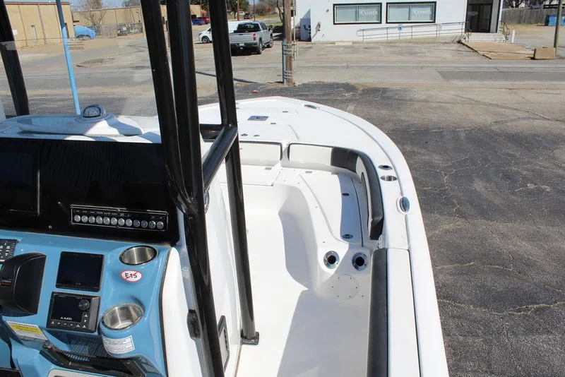 Slide: The Image of 2025 Tidewater 2300 CB boat interior with console and seating, parked in a lot. - 21