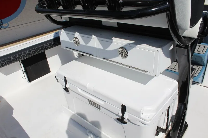 Slide: The Image of 2025 Tidewater 2300 CB boat interior with storage compartments and cooler. - 23
