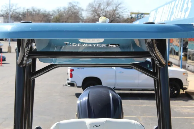 Slide: The Image of 2025 Tidewater 2300 CB boat with T-top, parked near a white truck. - 28