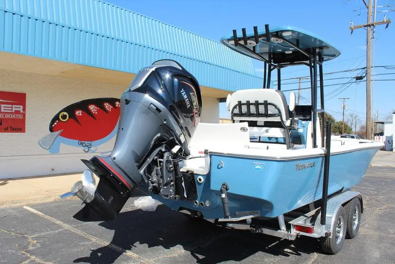 Slide: The Image of 2025 Tidewater 2300 CB boat on trailer, featuring a powerful outboard motor. - 7