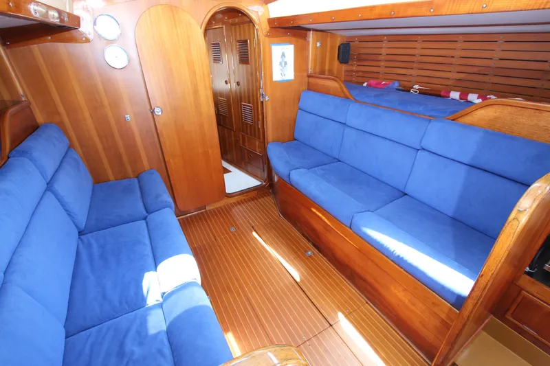 Slide: The Image of Interior of 1974 Nautor Swan 38 yacht with blue upholstery and wooden finishes. - 22