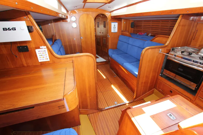 Slide: The Image of Interior of 1974 Nautor Swan 38 sailboat with wooden finish and blue seating. - 24