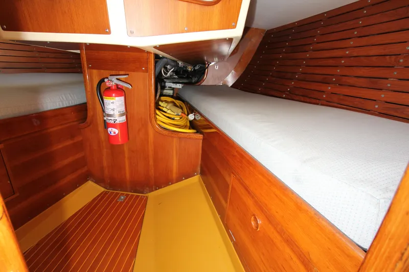 Slide: The Image of Interior of 1974 Nautor Swan 38 sailboat with wooden paneling and fire extinguisher. - 28