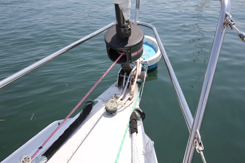 Slide: The Image of Bow of 1974 Nautor Swan 38 sailboat with ropes and winch on calm water. - 3