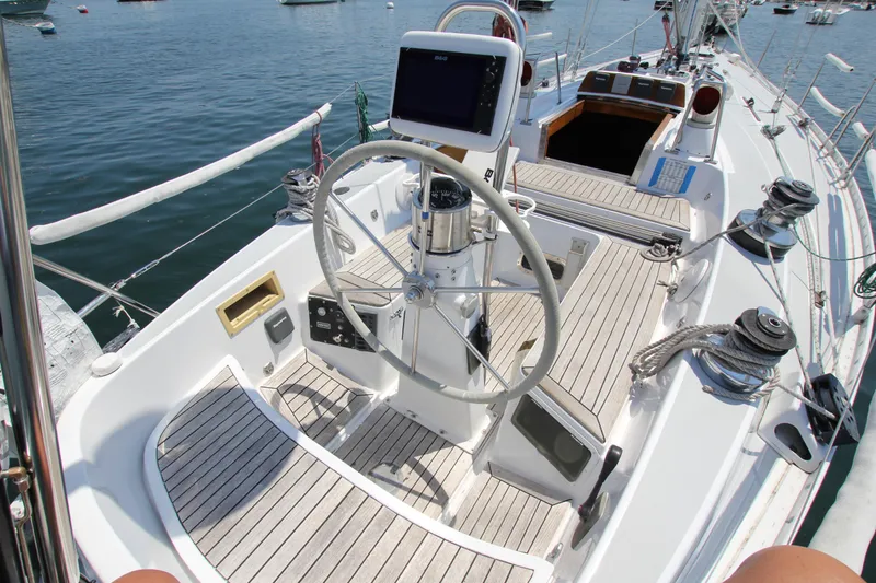 Slide: The Image of 1974 Nautor Swan 38 sailboat cockpit with steering wheel and navigation equipment. - 9