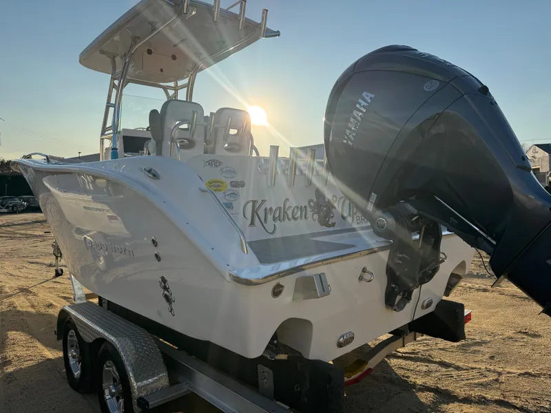 The Image of 2022 Cape Horn 22 OS boat with Yamaha outboard motor on trailer, sunlit background. - 10