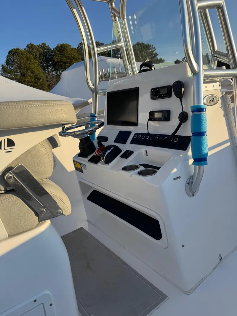 Slide: The Image of 2022 Cape Horn 22 OS boat console with modern controls and seating. - 14