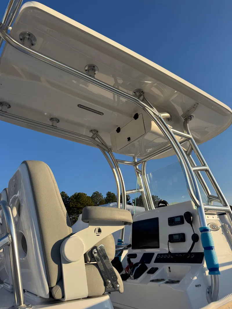 Slide: The Image of 2022 Cape Horn 22 OS boat console with T-top and seating, under clear blue sky. - 16