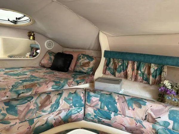 Slide: The Image of 1995 Cruisers Yachts 3175 Rogue cabin with floral upholstery and cozy interior design. - 13