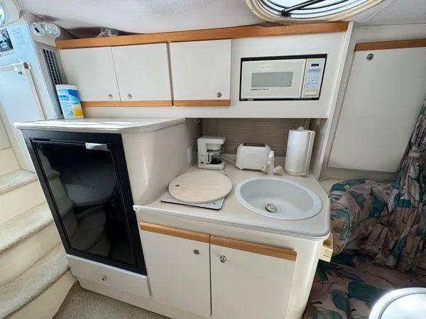 Slide: The Image of 1995 Cruisers Yachts 3175 Rogue kitchen with microwave, sink, and fridge. - 15