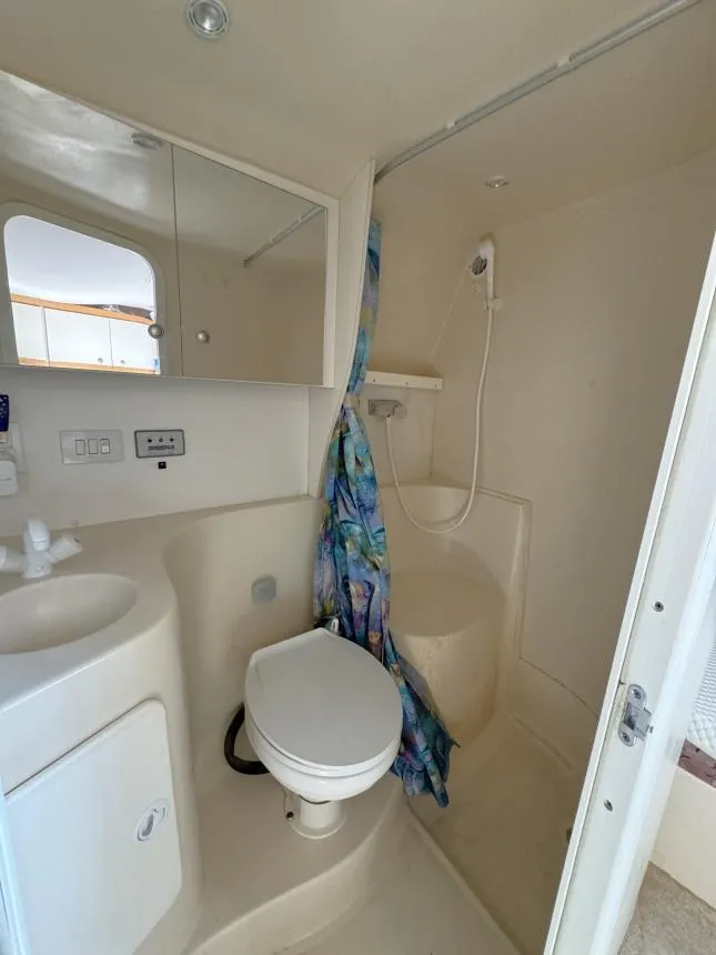 Slide: The Image of 1995 Cruisers Yachts 3175 Rogue bathroom with shower, toilet, and sink. - 16