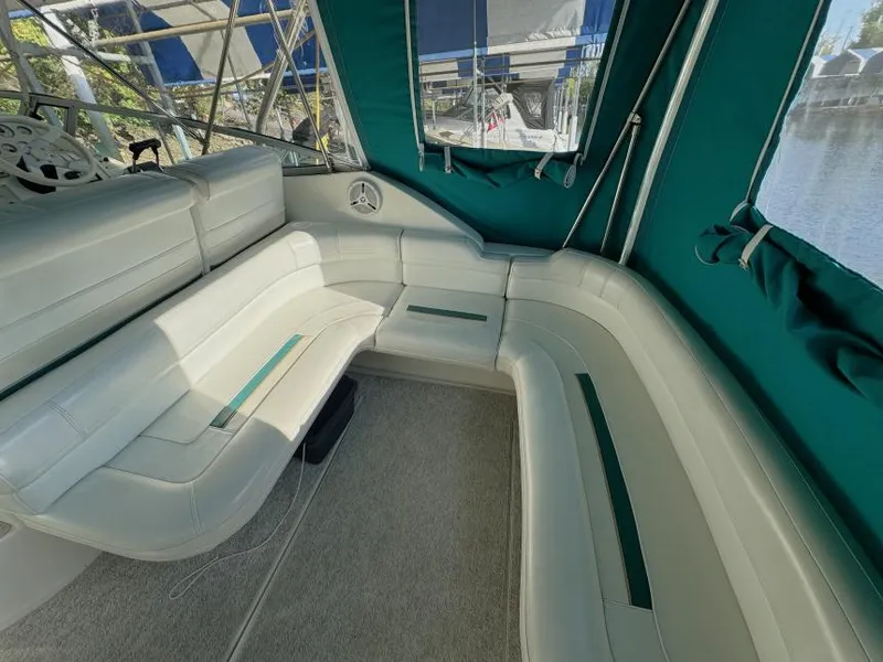 Slide: The Image of 1995 Cruisers Yachts 3175 Rogue interior with white seating and green accents. - 4
