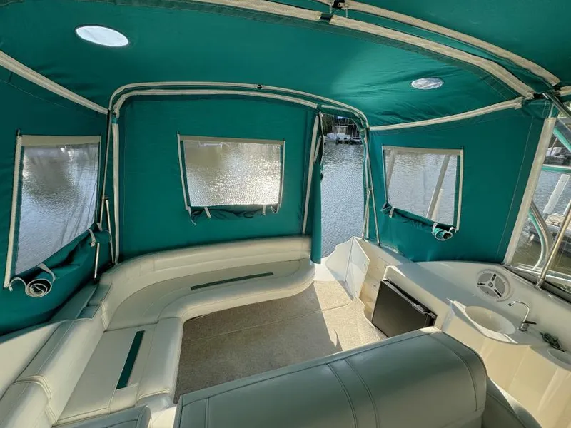 Slide: The Image of Interior of 1995 Cruisers Yachts 3175 Rogue with teal canopy and seating. - 5