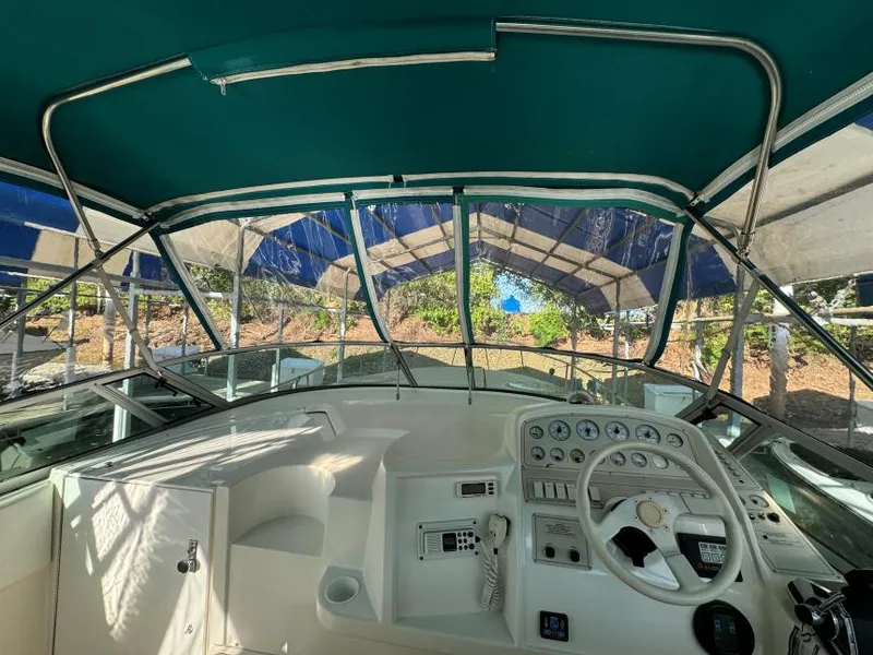 Slide: The Image of 1995 Cruisers Yachts 3175 Rogue cockpit with steering wheel and instrument panel under canopy. - 9