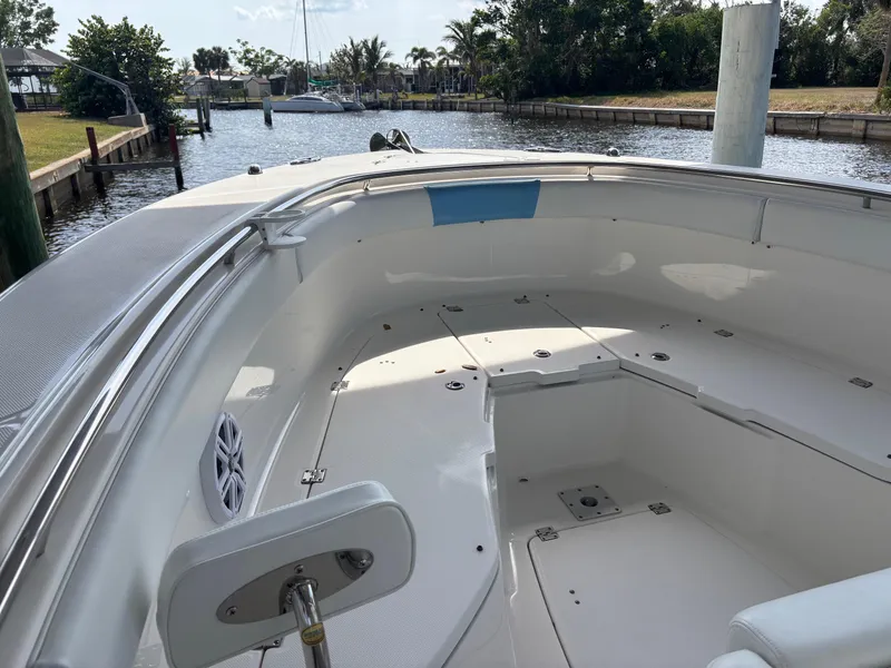 Slide: The Image of 2015 Robalo R300 Center Console boat docked in a serene marina setting. - 13