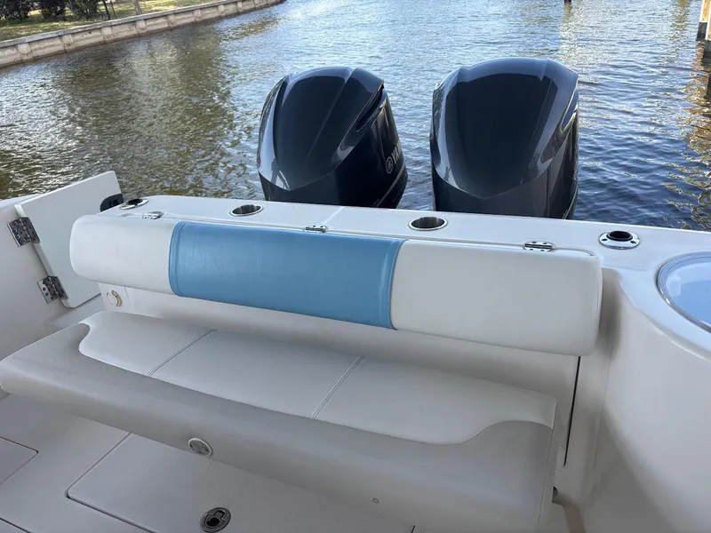 Slide: The Image of 2015 Robalo R300 Center Console boat with dual engines and cushioned seating. - 15