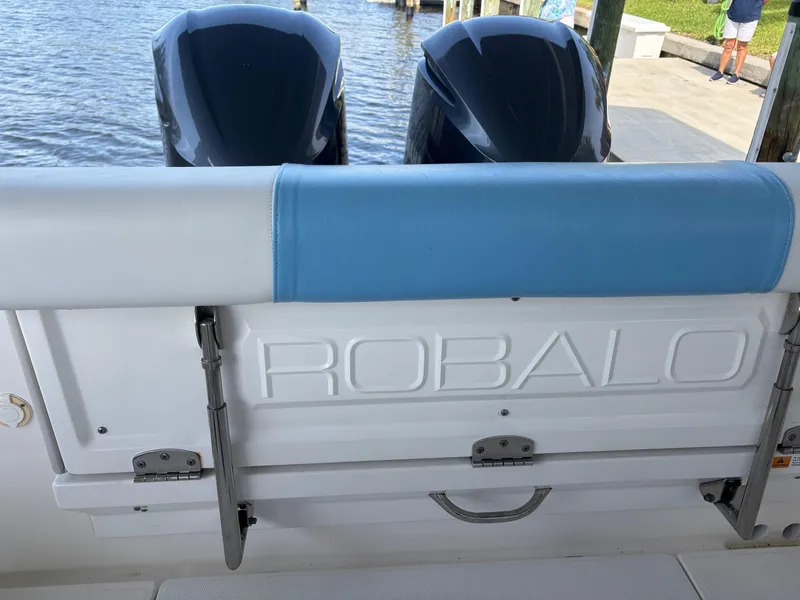 Slide: The Image of 2015 Robalo R300 Center Console boat with dual engines at dock. - 16
